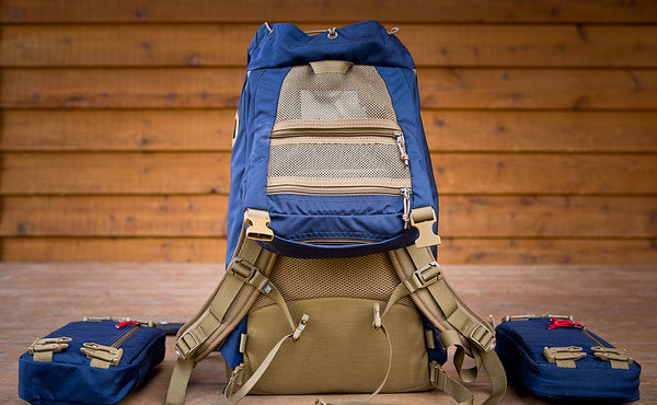 A Guide's Pack with the top flap open to reveal the two mesh zippered pockets.